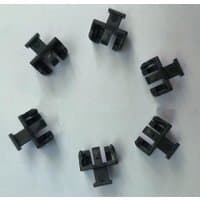 Black Microconnect SFP dust covers with a rectangular shape and dual prongs, arranged in a circular pattern.