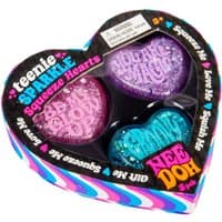 Heart-shaped NeeDoh Teenie Sparkle Hearts in pink, purple, and blue with glitter, in a colorful heart-shaped box.