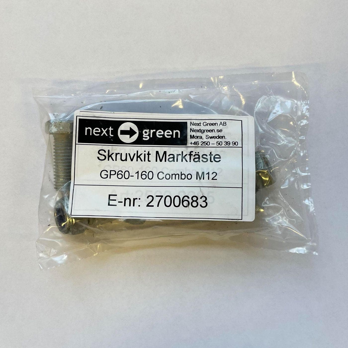 Next Green Ol Ki M16 package containing assorted screws and fasteners, labeled with product details and an E-number, secured in a transparent plastic bag.