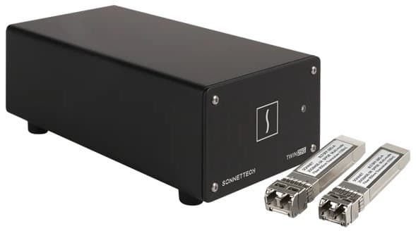 Black metal housing Ethernet adapter with dual Thunderbolt ports, labeled "TWIN25G" and two silver SFP28 transceivers on either side, designed for high-speed 25Gb connectivity.