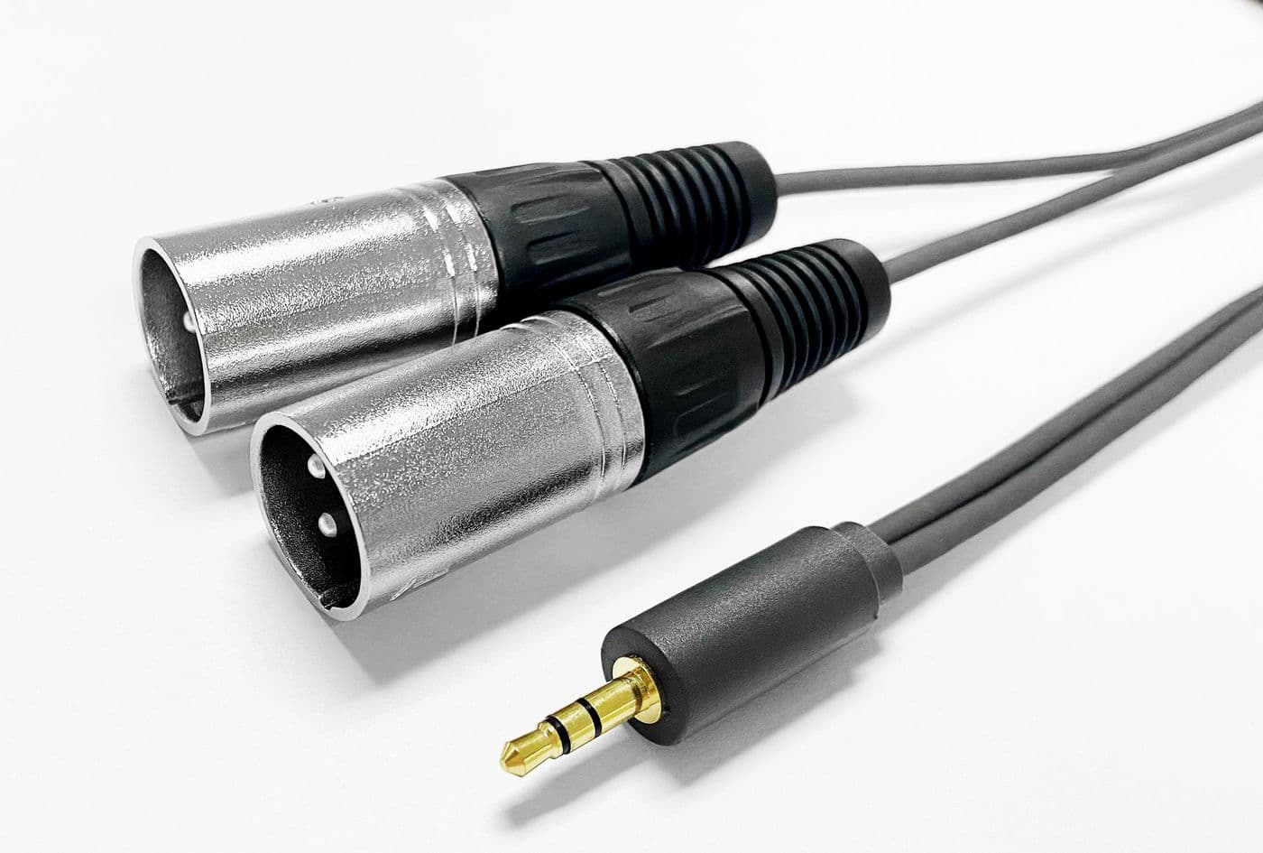 Black audio cable, 15 meters long, featuring two silver XLR connectors and a gold 3.5mm connector, designed for professional audio applications.