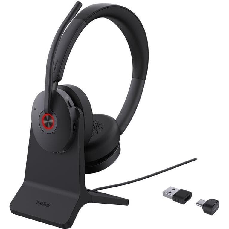 Black Yealink BH74 headset with a sleek design, featuring a padded earcup, adjustable headband, and a USB-C dongle, displayed on a matching stand.