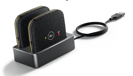 Two black Yealink CPW65 wireless microphones with gold accents, resting in a sleek charging dock with a USB cable attached, featuring indicator lights on each microphone.