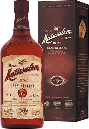 Matusalem Rum 15 Gran Reserva features a rich amber bottle with a vintage label, accompanied by a dark brown box, both showcasing elegant gold accents and the brand's logo.