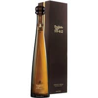 Tall amber bottle of Don Julio 1942 Anejo Tequila with elegant brown gift box.