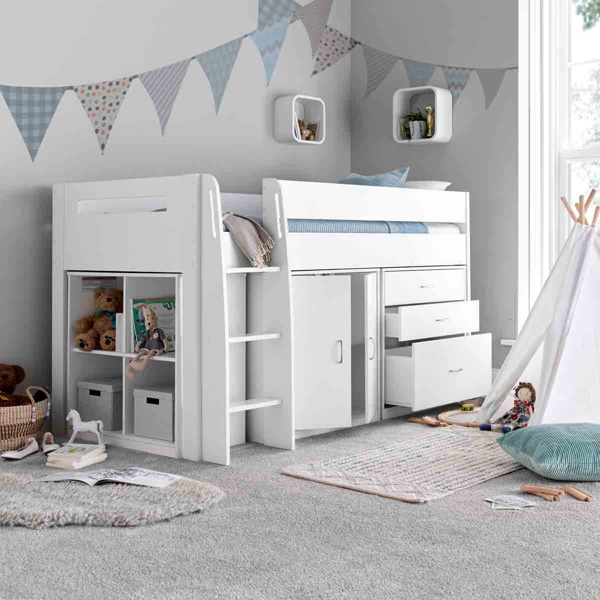 Lacy white mid sleeper bed with storage drawers and shelves, featuring a pocket sprung mattress, set in a cozy room with soft carpet and playful decor.