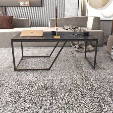 Wendy Metal Leg Coffee Table in Bendire Black features a sleek black metal frame, a minimalist design, and a rectangular top, set on a textured gray rug with modern sofas in the background.