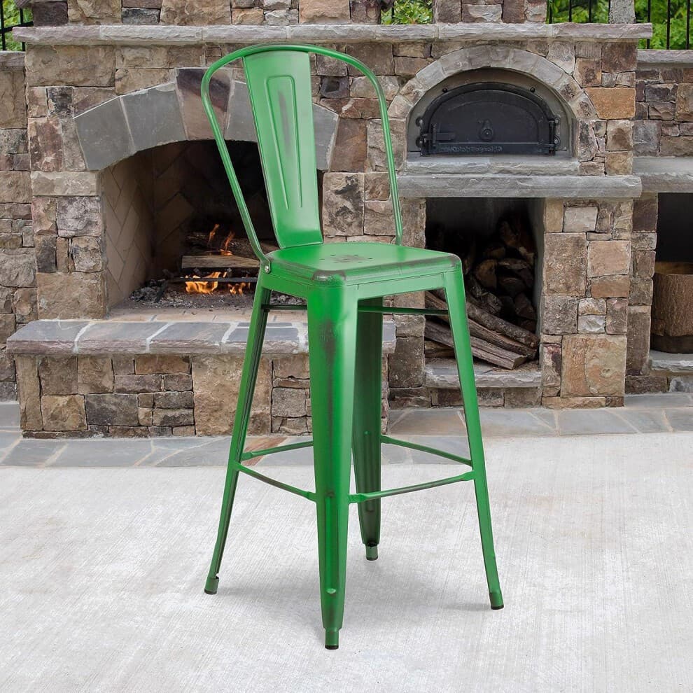 Set of 4 30" green distressed bar stools made of galvanized steel, featuring a classic industrial design with a high back and sturdy legs, set against a stone fireplace backdrop.