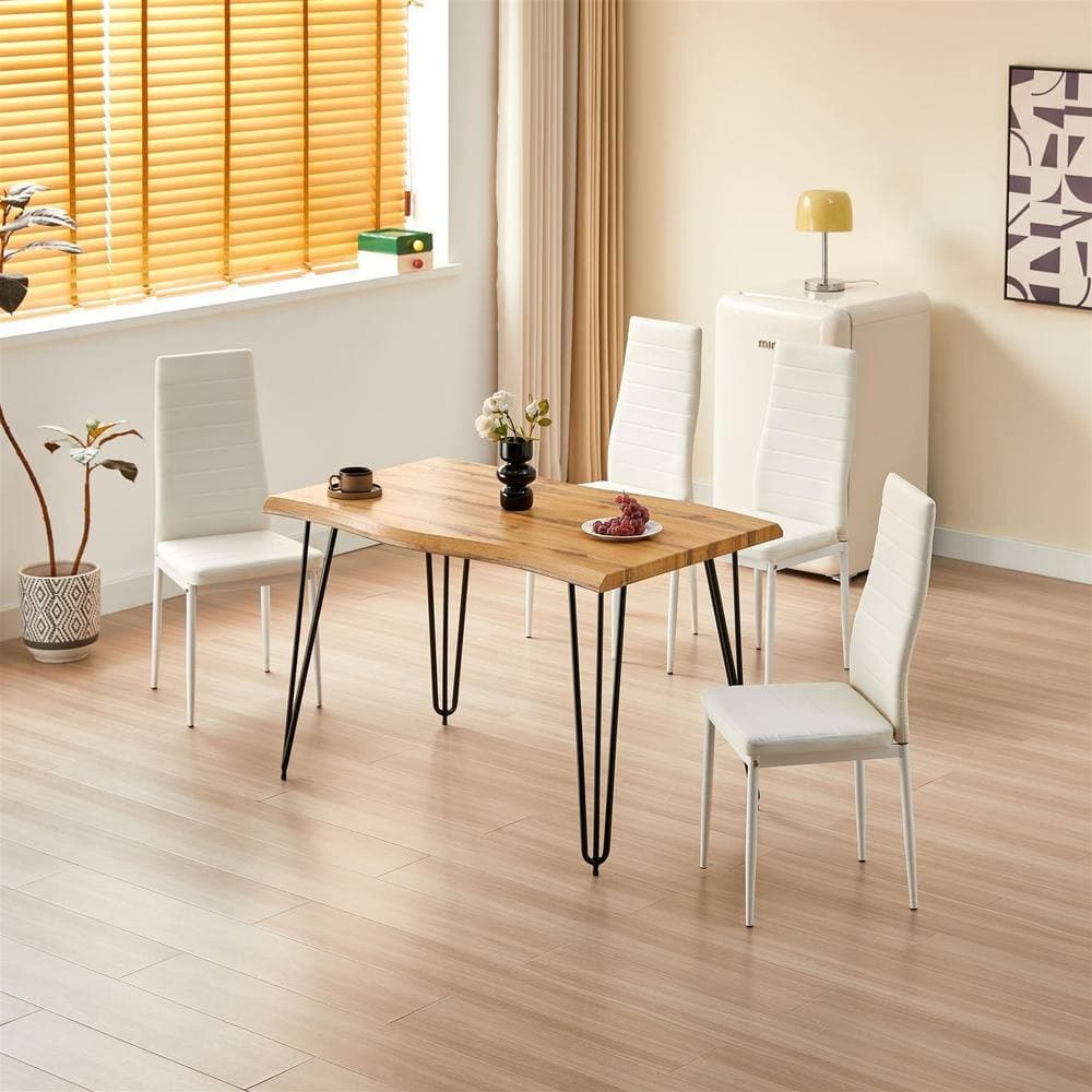 Modern dining table set featuring a brown wooden table with black metal legs and four white faux leather chairs, set in a bright room with natural light and minimal decor.