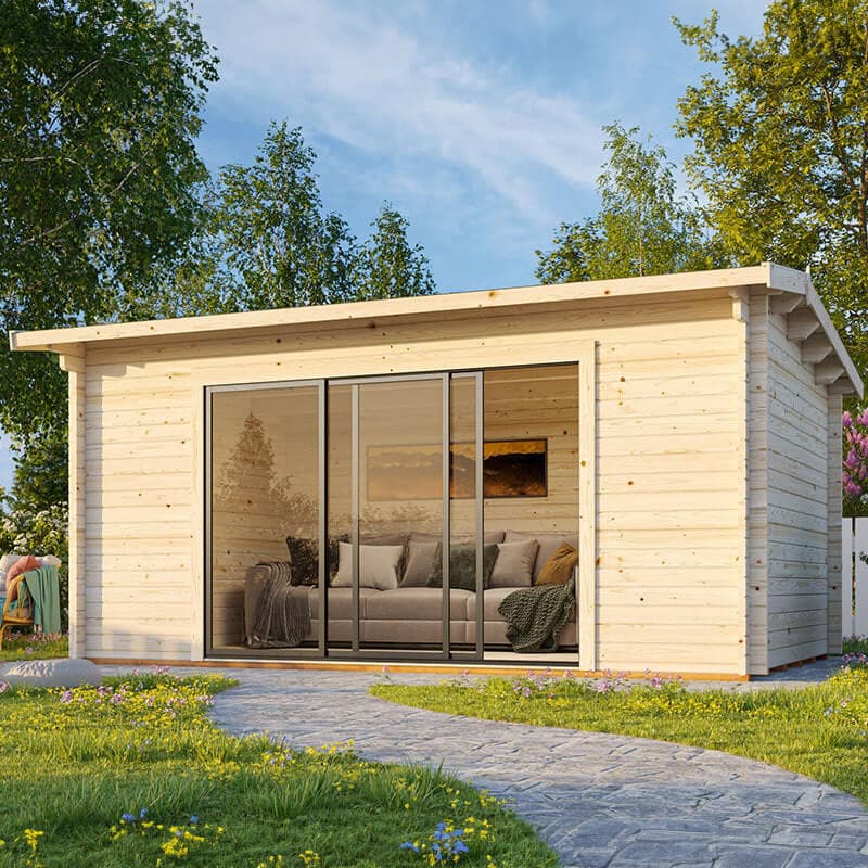 Light-colored wooden log cabin garden office featuring sliding glass doors, surrounded by greenery and a stone pathway, with a cozy interior visible through the doors.