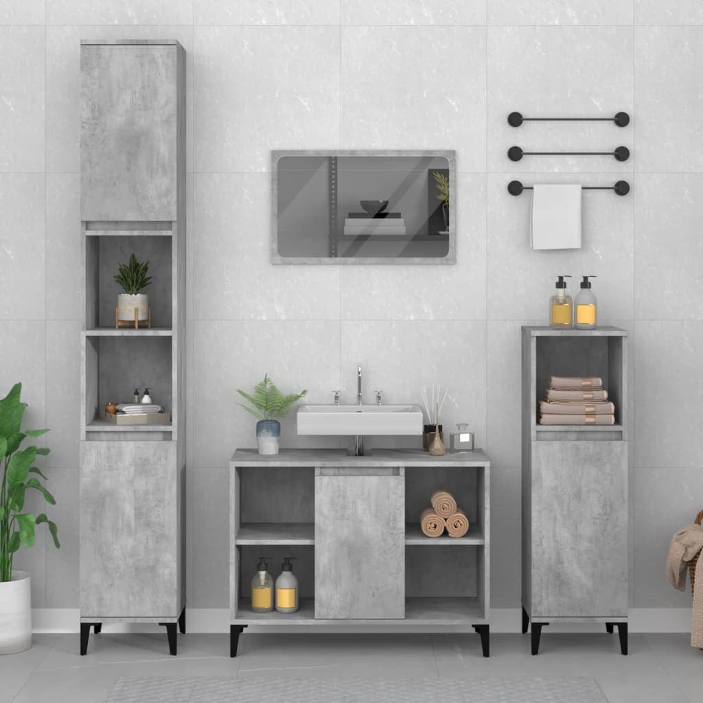 Concrete grey sink cabinet made of engineered wood, featuring two doors, open shelves, and sleek black legs, complemented by matching tall storage and wall-mounted accessories.