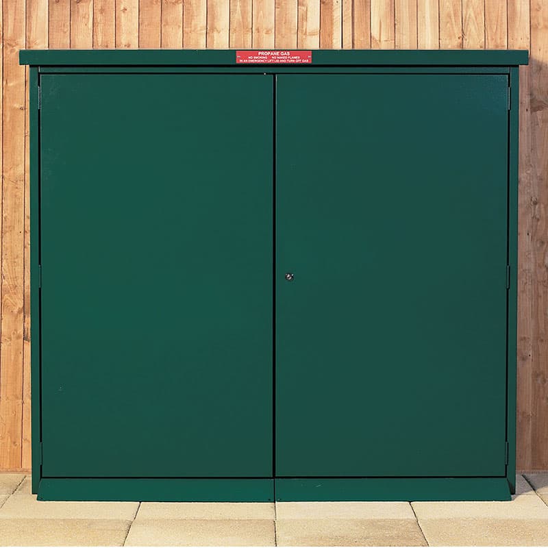 Green metal gas bottle storage unit with double doors, designed for 47kg bottles, featuring a warning sign on top and a sturdy, weather-resistant construction.