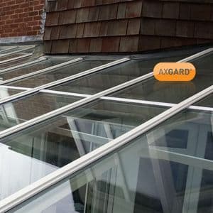 Clear 4mm polycarbonate roofing sheet with UV protection, measuring 620 x 2500mm, featuring a transparent finish and framed in silver, installed on a sloped roof.