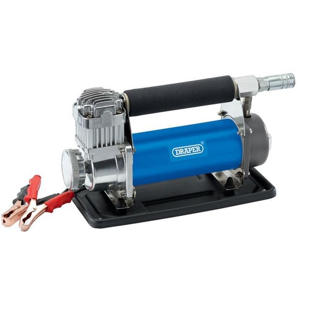 Compact blue and silver Draper 99074 DC Air Compressor with a rubber handle, metal body, and attached jumper cables, mounted on a black base.