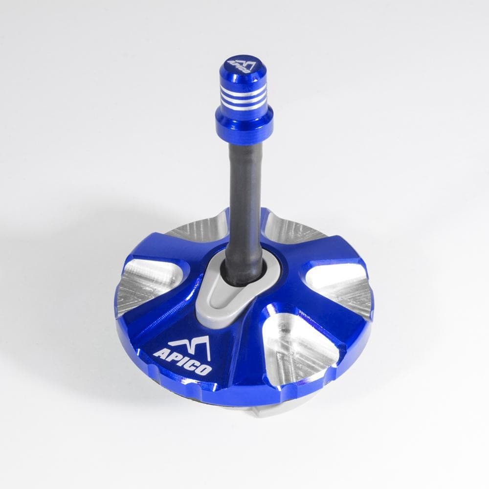 Blue alloy fuel cap with a 1/4 turn mechanism, featuring a textured grip and silver accents, designed for KTM and Husqvarna models from 2007 to 2023.
