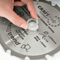 Circular saw blade with silver bush washer, carbide tipped, labeled "Trend Craft Pro" and "200mm, 30mm bore."