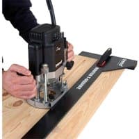 Black Trend RTS/1000 Router T Square with red handle, used on wooden surface for precise cutting.