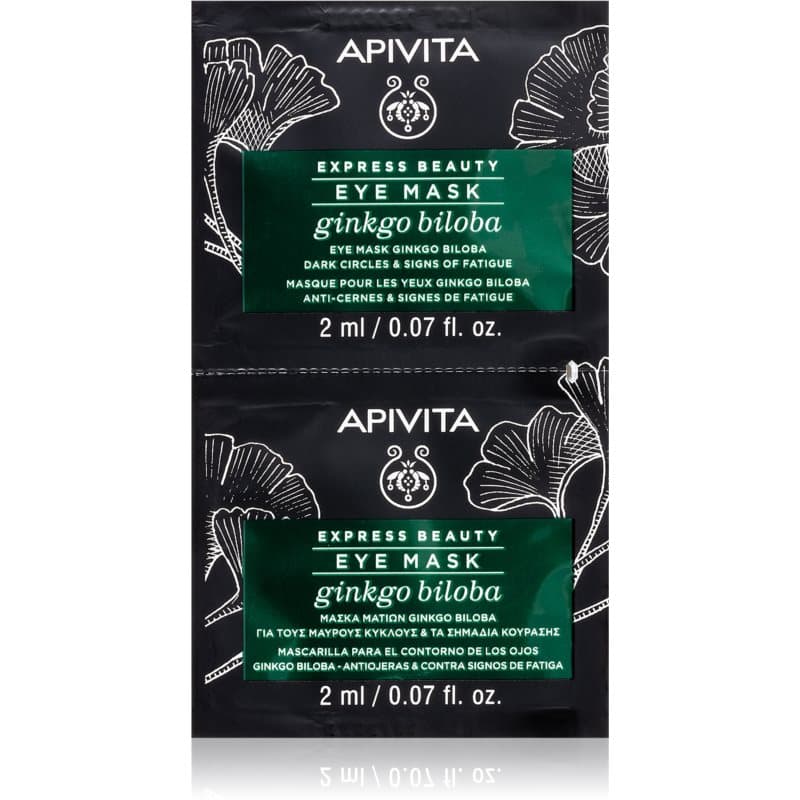 Two black sachets of APIVITA Express Beauty Eye Mask featuring ginkgo biloba, each 2ml, with green text highlighting anti-dark circles and fatigue benefits.