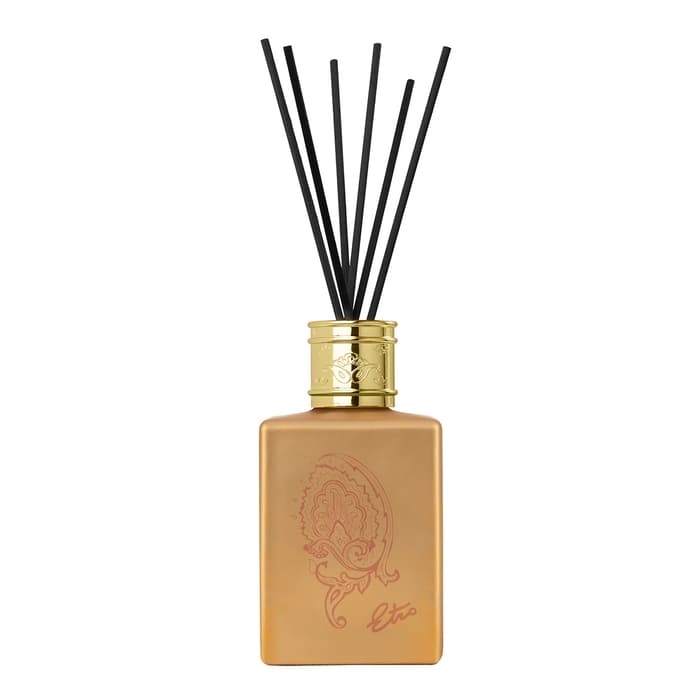 Saffron gold diffuser set in a sleek square glass bottle with a gold cap, featuring a decorative paisley design and black reed sticks for fragrance diffusion.