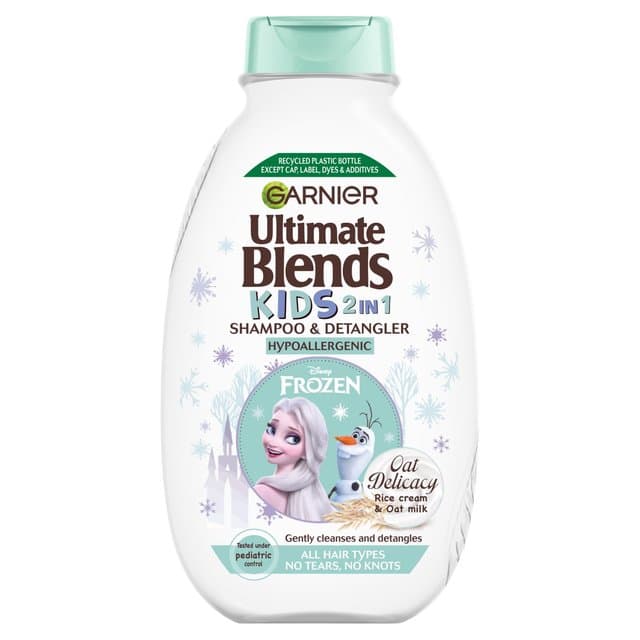 White bottle with a turquoise cap, featuring a Frozen-themed design and characters. Label highlights "Ultimate Blends Kids 2-in-1 Shampoo & Detangler" with oat milk and rice cream ingredients.