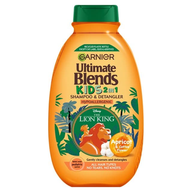 Bright orange bottle of Garnier Ultimate Blends Kids 2-in-1 Apricot Shampoo, featuring Lion King graphics, with a flip-top lid and a label indicating it's hypoallergenic and suitable for all hair types.