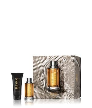 Hugo Boss the Scent gift set featuring a 50 ml EDT bottle with a sleek silver cap and a 100 ml shower gel in a black tube, all presented in an elegant box with a textured design.