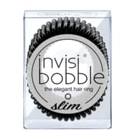 A transparent box containing three slim, black Invisibobble hair rings, featuring a spiral design for gentle hair hold without damage.