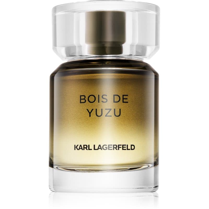 Clear glass bottle with a round, transparent cap; the fragrance is a gradient from gold to amber, featuring "BOIS DE YUZU" and "KARL LAGERFELD" printed in black.
