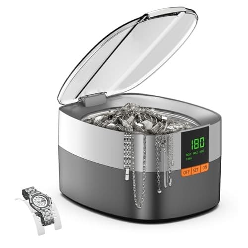 Ultrasonic cleaner with a sleek gray and silver design, featuring a transparent lid, digital display, and a watch alongside various pieces of jewelry inside.