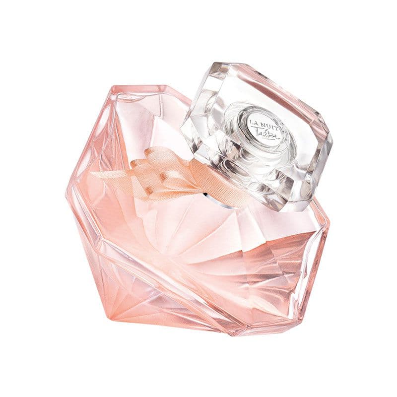 Clear crystal bottle with a diamond shape, featuring a soft pink liquid and a delicate ribbon around the neck, labeled "LANCÔME La Nuit Trésor Nude Eau De Toilette 50ml."