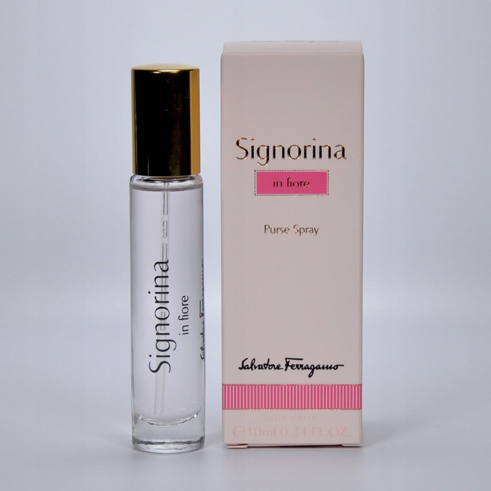Clear glass 10ml perfume spray with a gold cap, labeled "Signorina in fiore," beside a pink and white box featuring the Salvatore Ferragamo logo.
