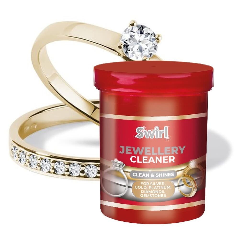 Red container of Swirl Jewellery Cleaner (145ml) with a shiny gold ring featuring a large diamond and a band adorned with smaller diamonds in the background.