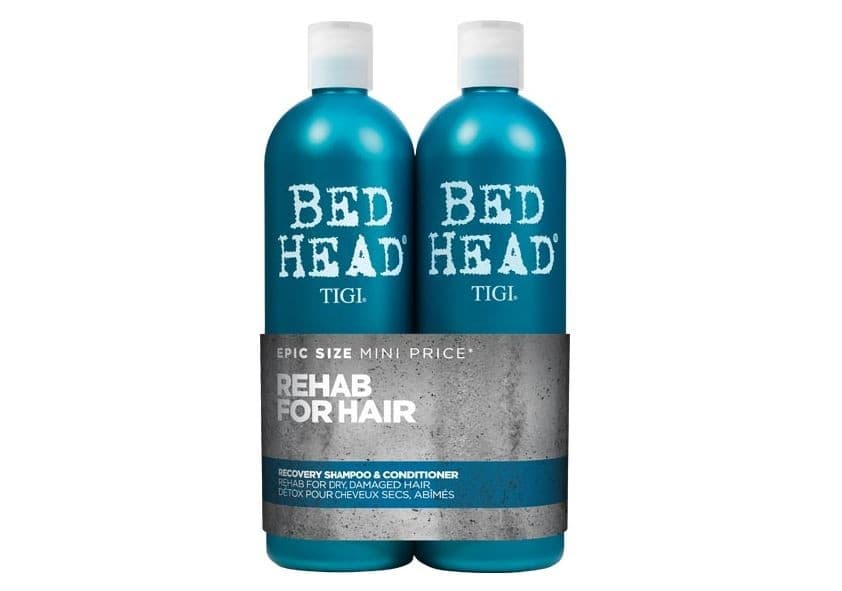 Two turquoise bottles of TIGI Bed Head Recovery Tween Duo Pack, labeled "Rehab for Hair," designed for dry, damaged hair, featuring a sleek, modern design with a grey band.