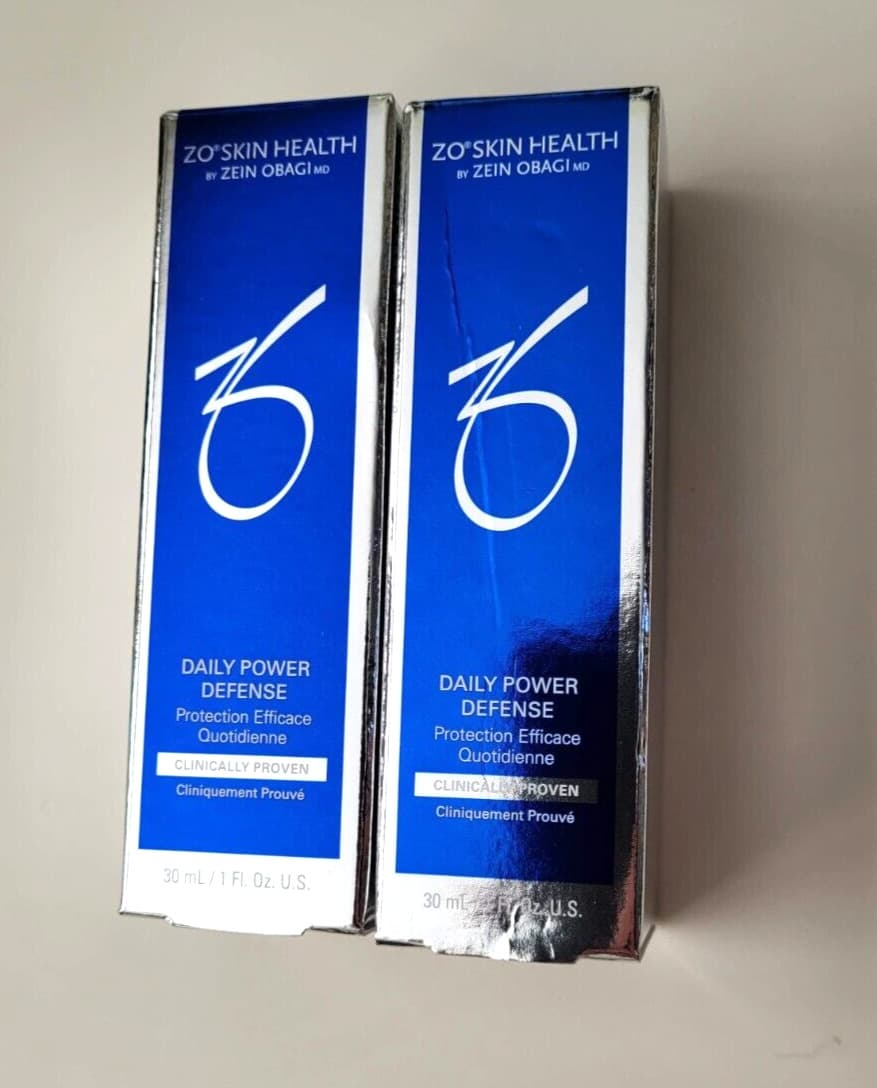 ZO Skin Health Daily Power Defense in a sleek blue and silver box, featuring a prominent logo and text, highlighting its travel size of 1oz/30ml and clinical efficacy.