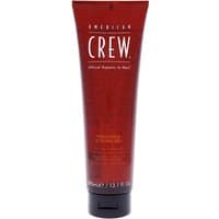 Red tube of American Crew Firm Hold Gel, 390ml, with white text and black flip cap.