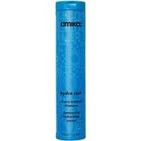 Blue cylindrical bottle of Amika Hydro Rush Intense Moisture Shampoo with intricate circular patterns, 275ml.