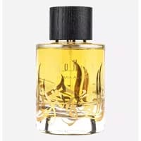 Clear glass bottle of Ard Al Zaafaran Thara Al Oud Eau De Parfum with black cap and gold Arabic script, 100ml.