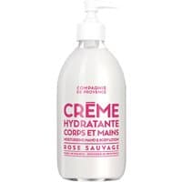 White bottle of Compagnie De Provence Wild Rose Body and Hand Cream with pink text and pump dispenser.