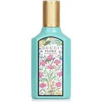 Turquoise Gucci Flora Gorgeous Jasmine perfume bottle with gold cap and floral label.