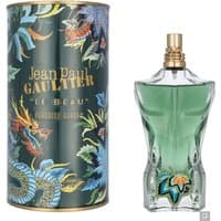 Green torso-shaped bottle with gold cap, next to floral-patterned cylindrical box, "Jean Paul Gaultier Le Beau" text.