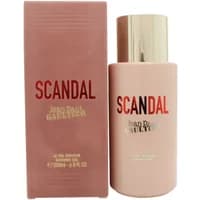 Pink Jean Paul Gaultier Scandal shower gel bottle with gold cap, next to matching pink box with red and gold text.