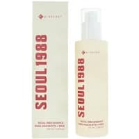 K-Secret SEOUL 1988 Essence, translucent bottle with pump, snail mucin 97% and rice, next to matching box.