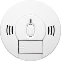 White Kidde smoke and carbon monoxide alarm with central test button and side vents.