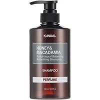 KUNDAL Honey & Macadamia shampoo in a dark amber pump bottle with pink grapefruit label, 500ml.