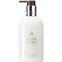 White Molton Brown body lotion bottle with black pump, silver collar, and logo text, 300 ml size for men.