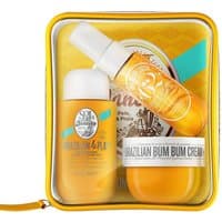 Sol De Janeiro Bum Bum Jet Set with yellow spray, cream jar, and shower gel in a clear yellow-trimmed pouch.