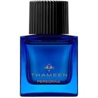 Blue glass bottle of Thameen Peregrina Extrait de Parfum with black ribbed cap and gold logo.