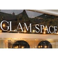 Glam Space Aberdeen storefront with large white letters on glass, warm interior lighting visible through windows.