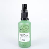 Green bottle of UpCircle Hand & Body Wash with black pump, labeled lemongrass, 50ml travel size.