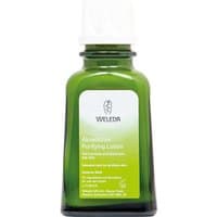 Green glass bottle of Weleda Aknedoron Purifying Lotion with white cap and green label, 50ml size.